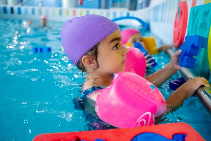 girl with water wings in swimming pool