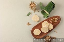 Raw tempeh on wooden plate with space for text 4dp2Q4