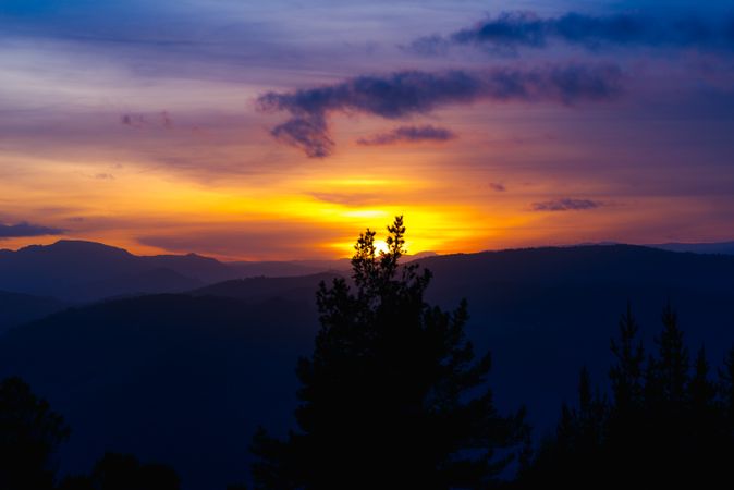 Cloudy sunset sky over hills
