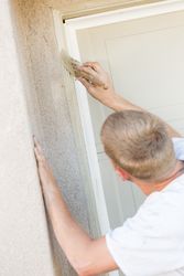 Professional Painter Cutting In With Brush to Paint Garage Door Frame
