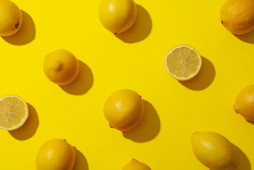 Flat lay composition with lemons on yellow background