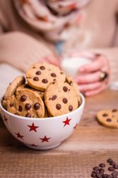 Chocolate chip cookies on stars bowl over a table