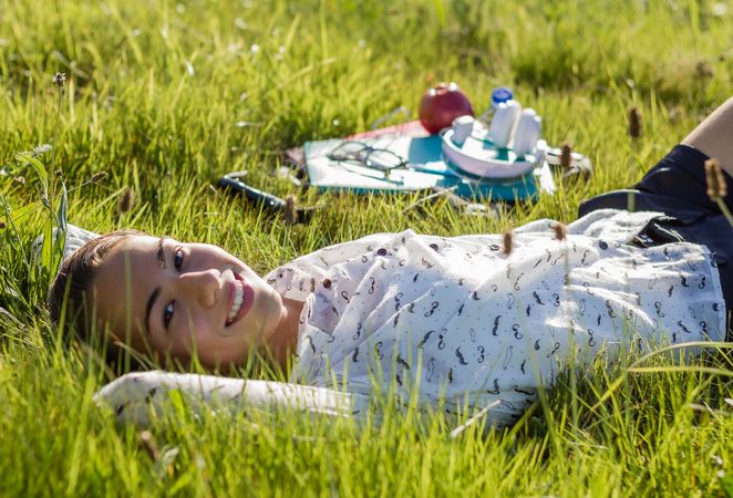 young student lying at the park in a sunny day