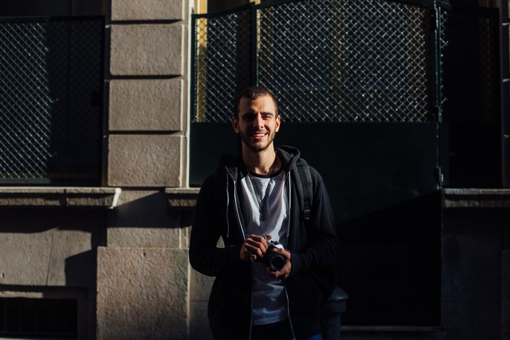 Man smiling while holding camera