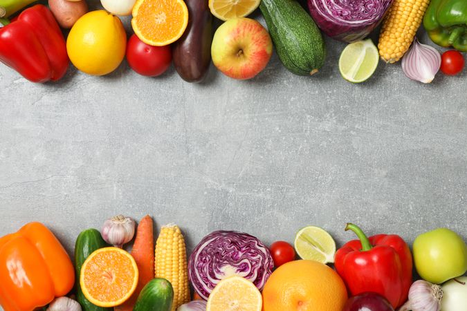 Different vegetables and fruits on grey background, copy space