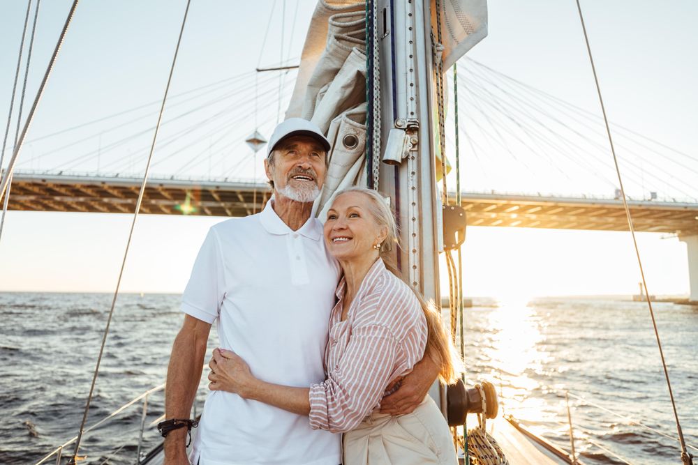 Loving older couple enjoying the view on a sailboat