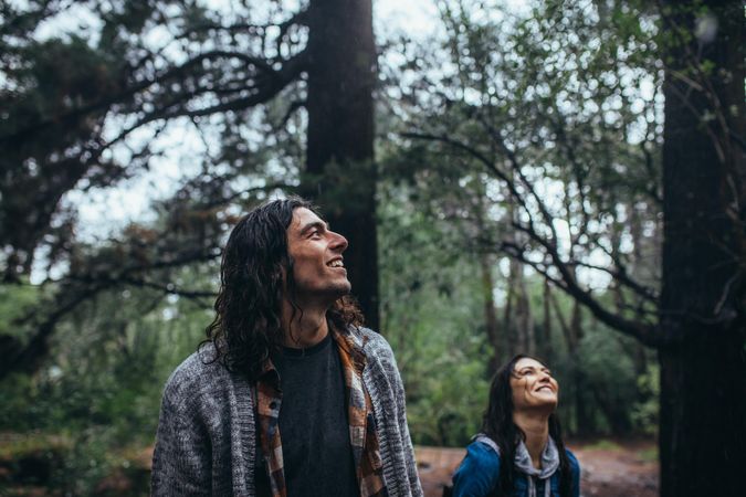 Man admiring nature with happy woman behind him