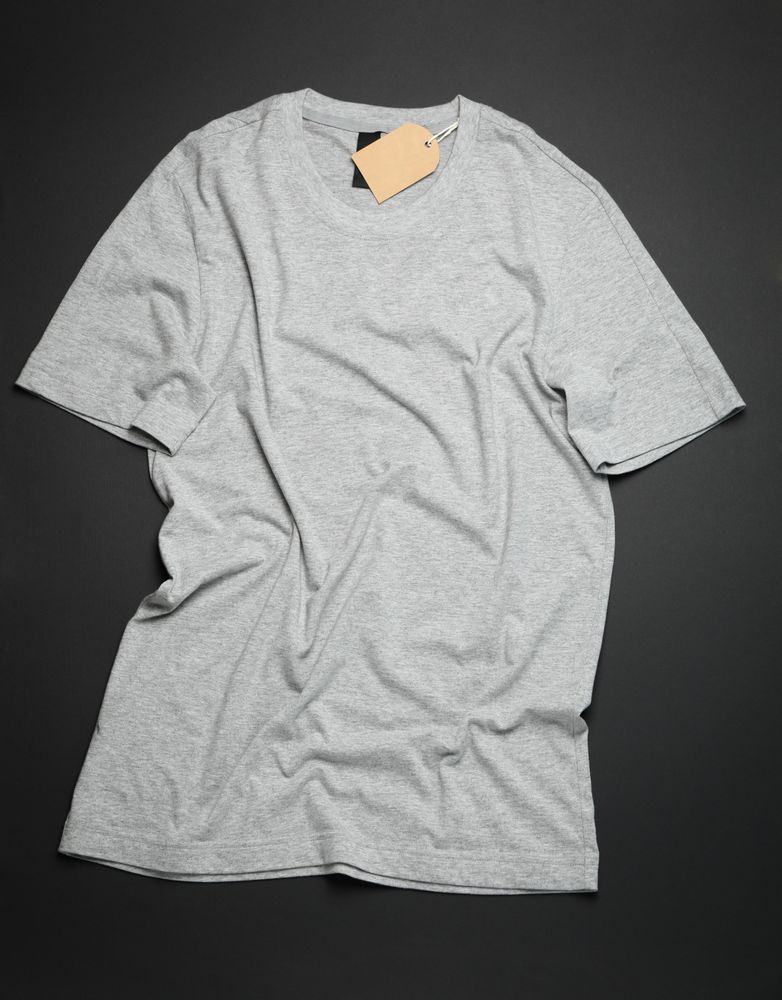 Crumpled blank gray t-shirt on dark background, space for text