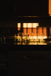 empty glasses under dramatic light in kitchen