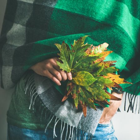 Woman holding fall leaves