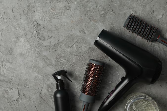 Composition with hairdresser accessories on gray background, space for text