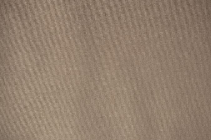 Detailed flat view Light brown pattern fabric texture background.