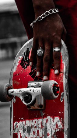 Close-up shot of Black hand holding a skateboard