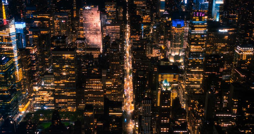 Scenic Aerial New York City View of Downtown Manhattan Architecture. High Angle Night Photo of the Business District from a Helicopter. Cityscape with Office Buildings and Busy Traffic on Streets