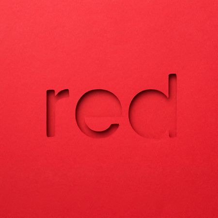 Red word made of paper over red background