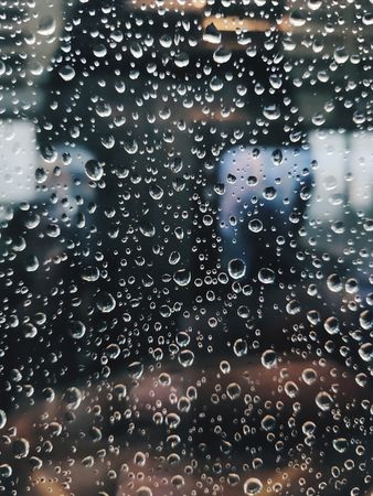 Rainy Day Reflections: A Close-Up View of Water Droplets on Glass