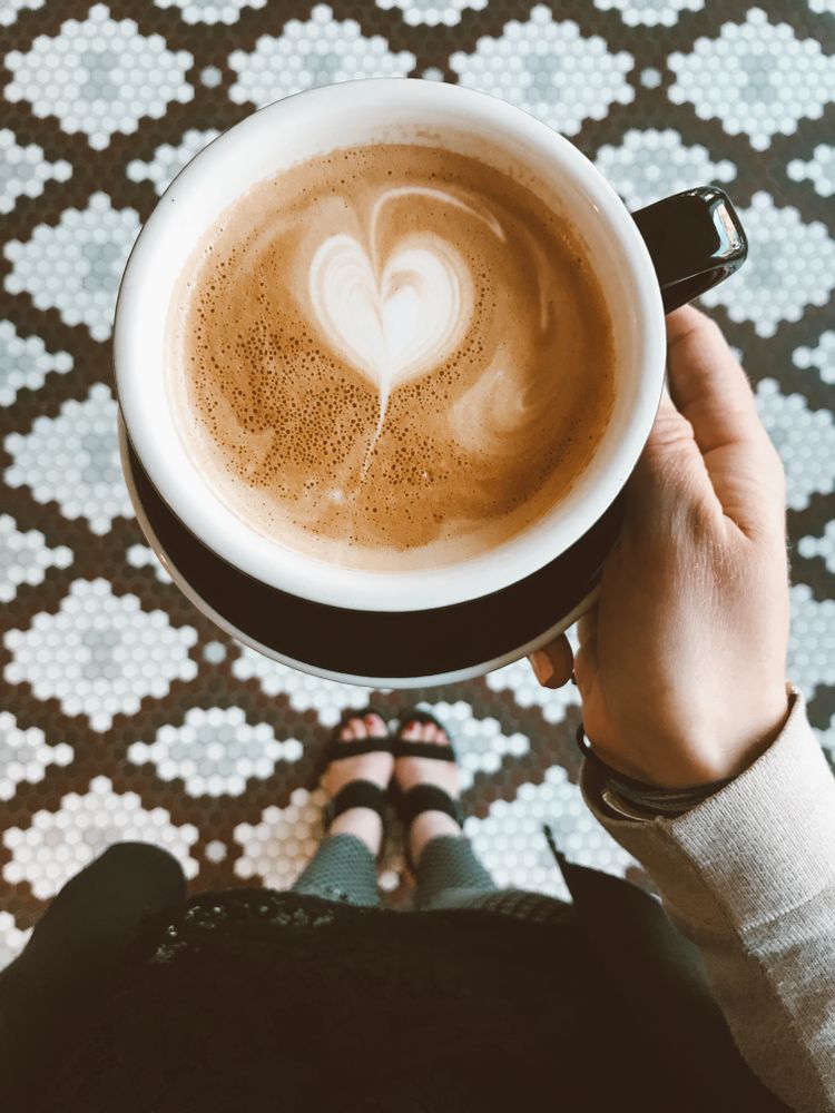 Heart shaped latte art inside coffee mug