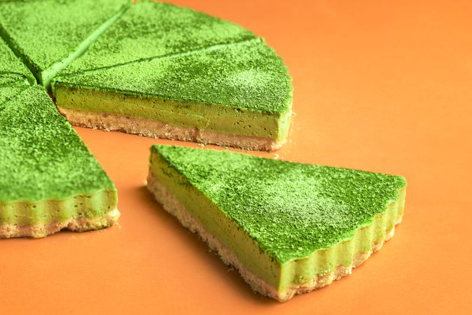 Side profile of sliced cheesecake made with matcha