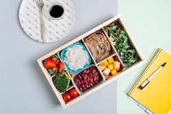 Food box with diet ingredients by copybook and plate