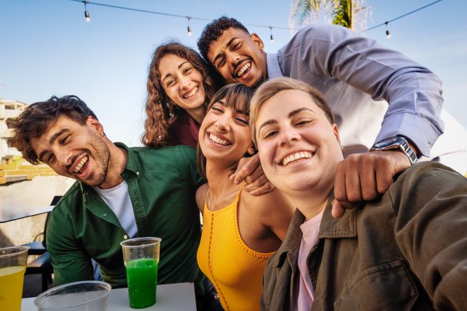 Joyful Friends Enjoying Seaside Drinks - Beach Gathering