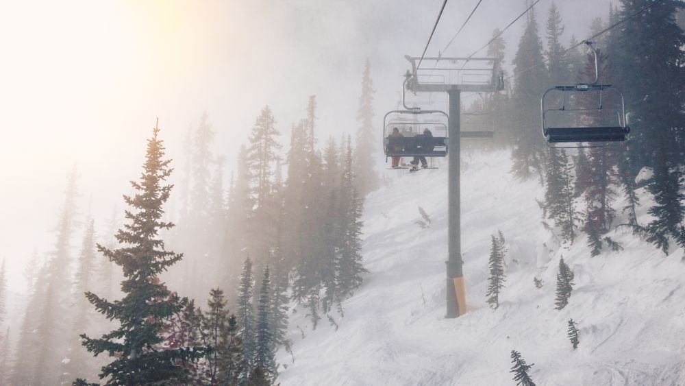People on chairlift upping on snow mountain
