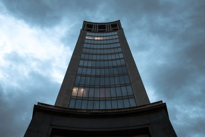 Contemporary highrise building under cloudy sky