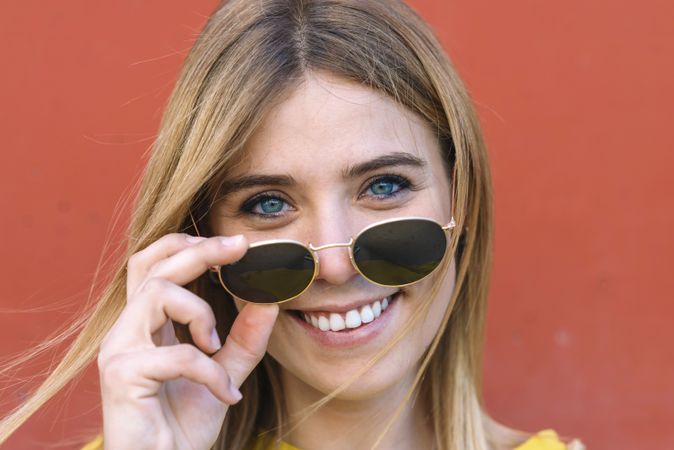 woman in sunglasses smiling at camera