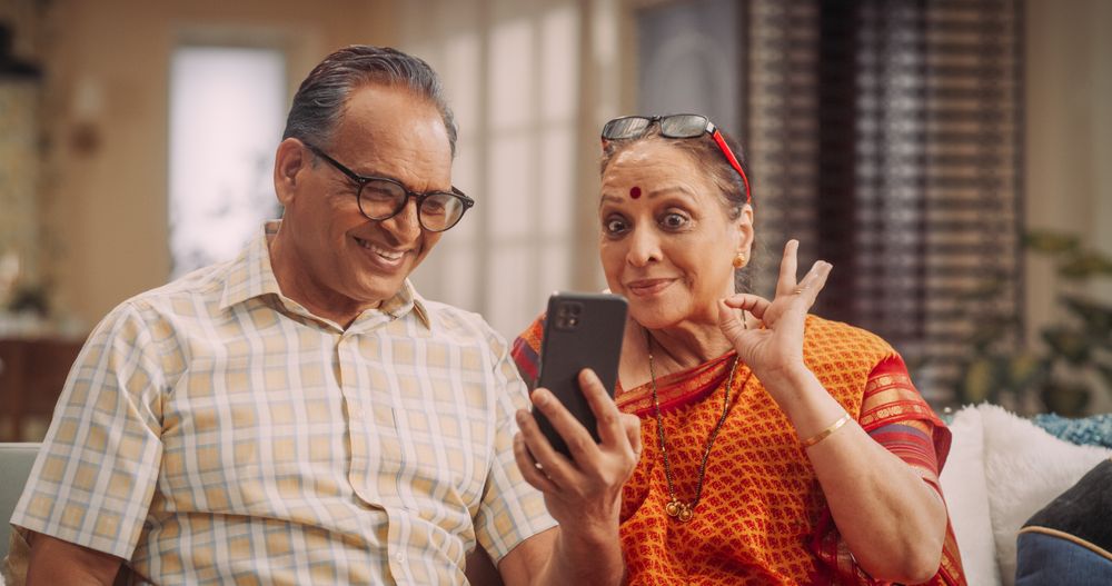 Mature Couple Using Smartphone for Video Call at Home