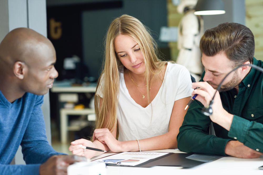 Multi-ethnic colleagues working through graphs at work