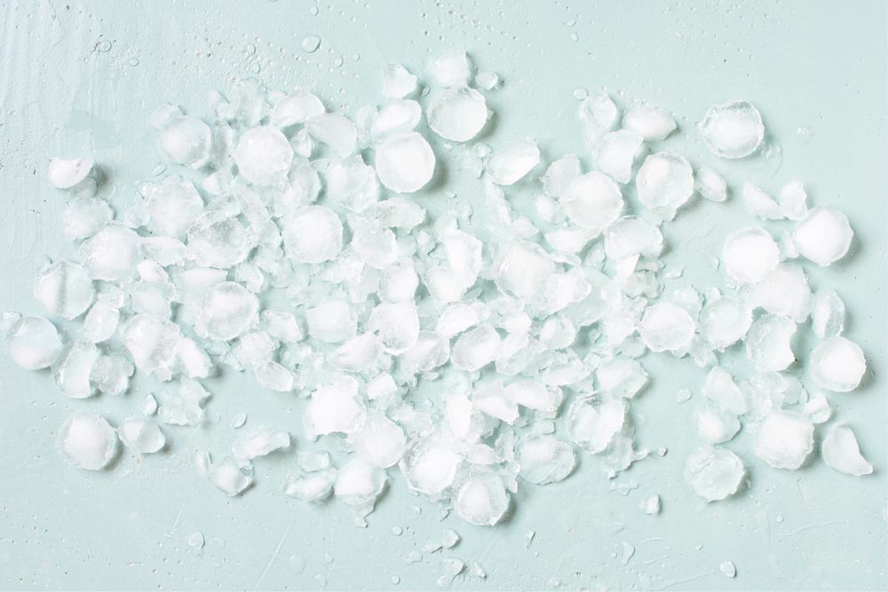 Crushed ice on baby blue background