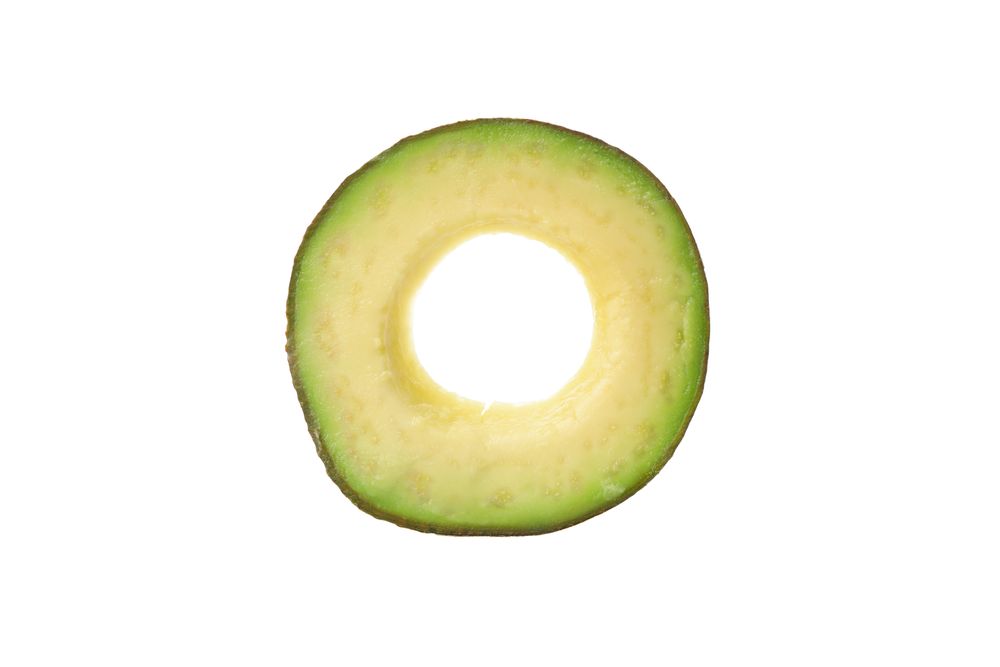 Ripe fresh avocado slice isolated on plain background