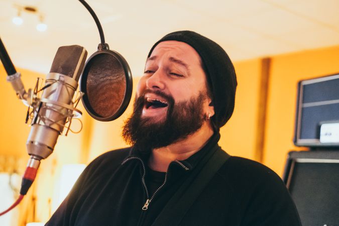 Musician playing guitar and singing