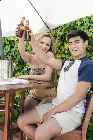 Young couple drinking beer on a sunny day
