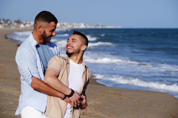 Gay couple walking on beach