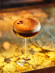 Espresso martini with coffee beans in bar