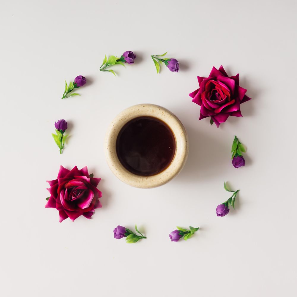 Flowers arranged in circle with coffee mug