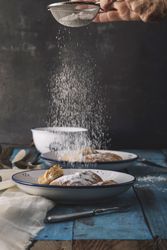 Faceless baker cooking sweet rolls on wooden table