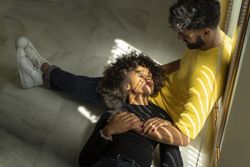 Black woman lying on knees of boyfriend