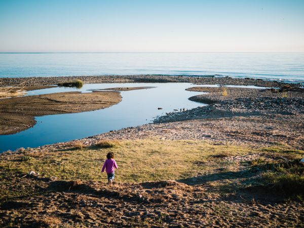 small girl walking by the beach