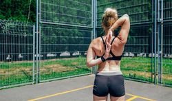 Sportswoman doing arm stretches