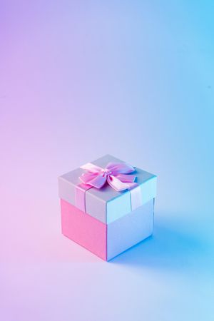 Wrapped present on vibrant bold gradient holographic colors
