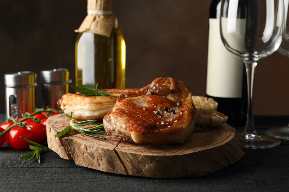 Composition with fried steaks and wine. Grilled food