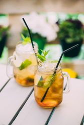 Mojitos in mason jar on wooden table