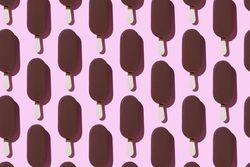 Chocolate popsicle in neat order on pink background