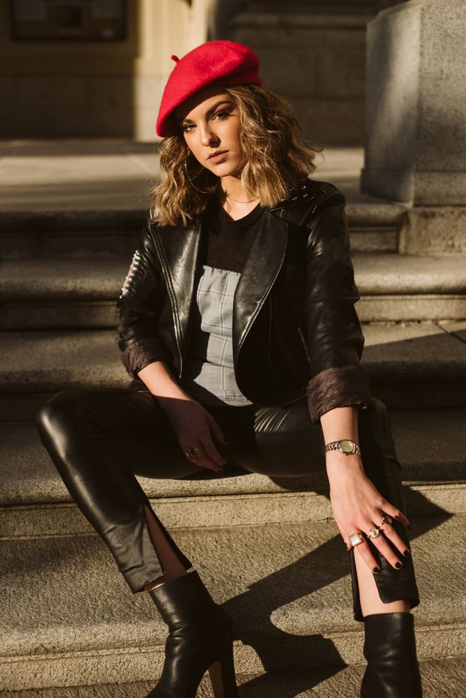 Stylish female in beret looking at camera