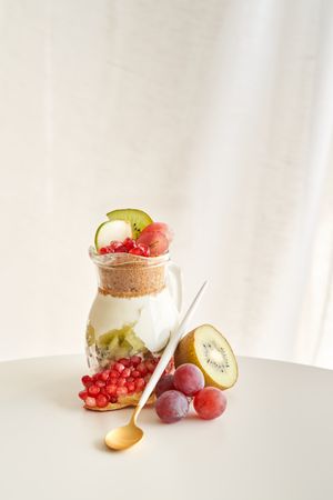 Delicious yogurt dessert with pomegranate, kiwi, grape and ginger biscuit