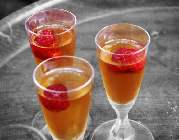 Elegant Bubbles: Macro Champagne Glasses with Fresh Raspberries