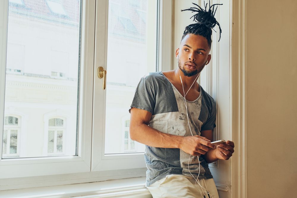 Cheerful Black male listening to music