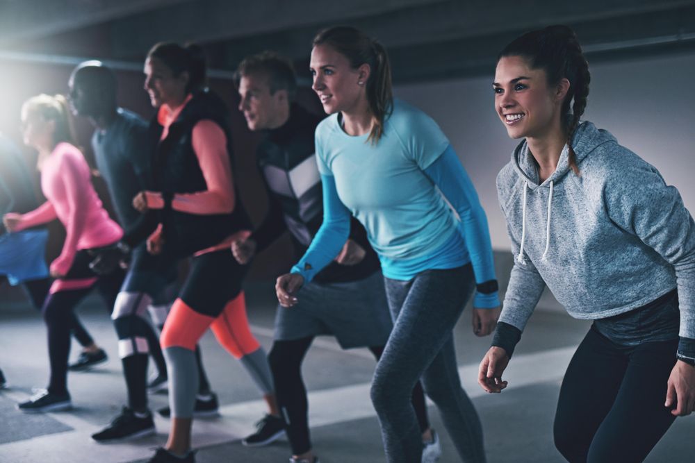 Multi-ethnic group of people at starting line of running track