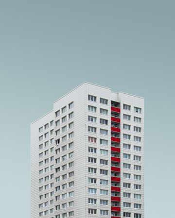 Light grey building with red detail